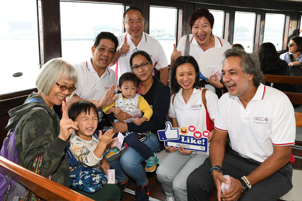 Chamber leaders greet passengers and hand out HKGCC souvenirs on board the Star Ferry.