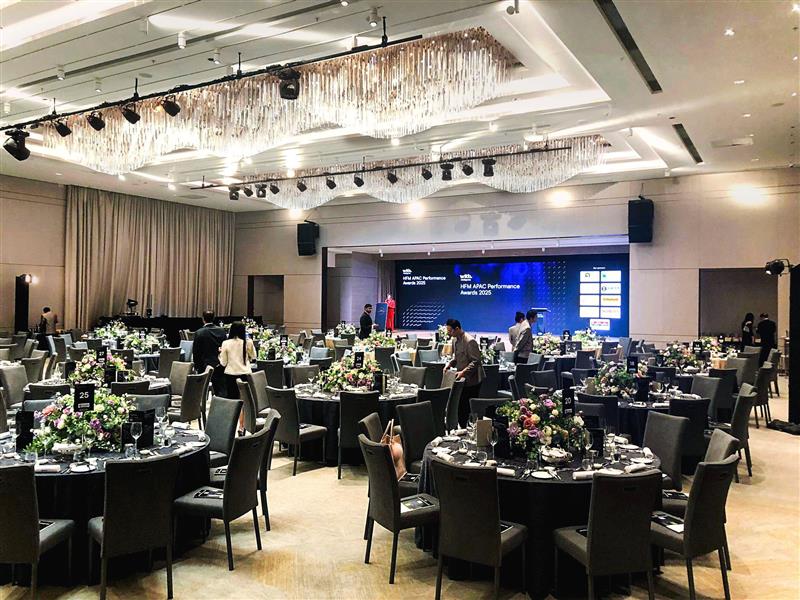 Audience seated facing a large LED screen